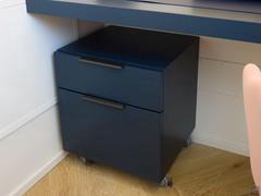 Office chest of drawers on wheels, matte lacquered blue.